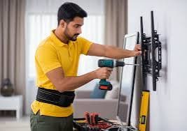 Nishant TV Installation technician drilling a wall mount bracket for a professional TV installation